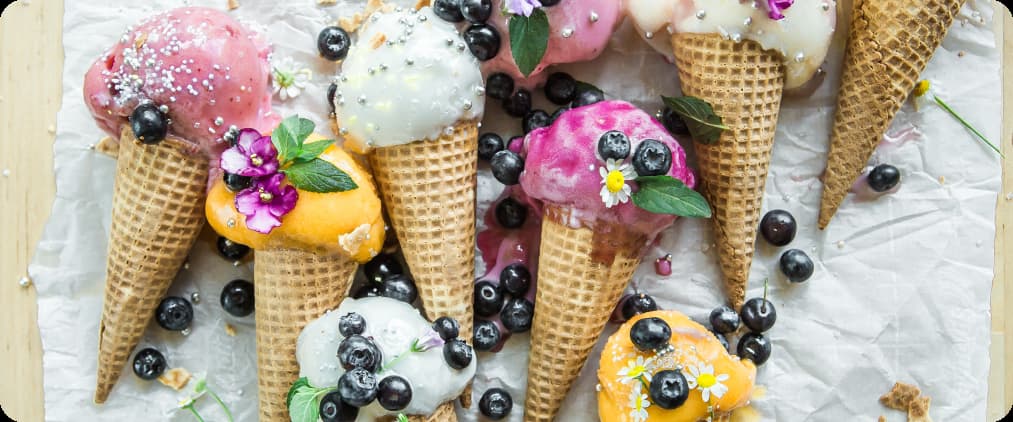 lots of ice cream with different flavors in waffle cones